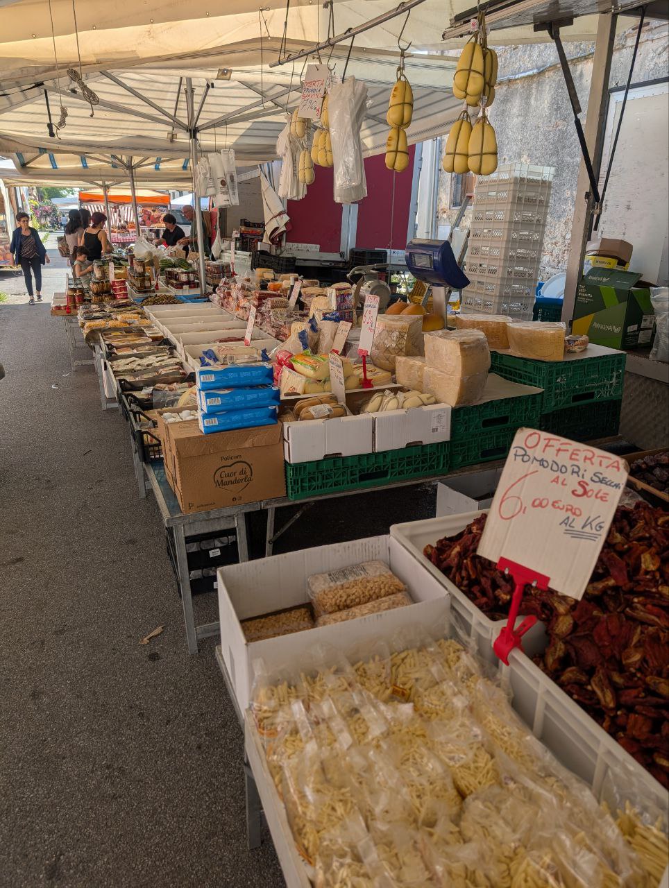 Local farmers market in Mileto with cheeses, dried tomatoes, and homemade pasta
