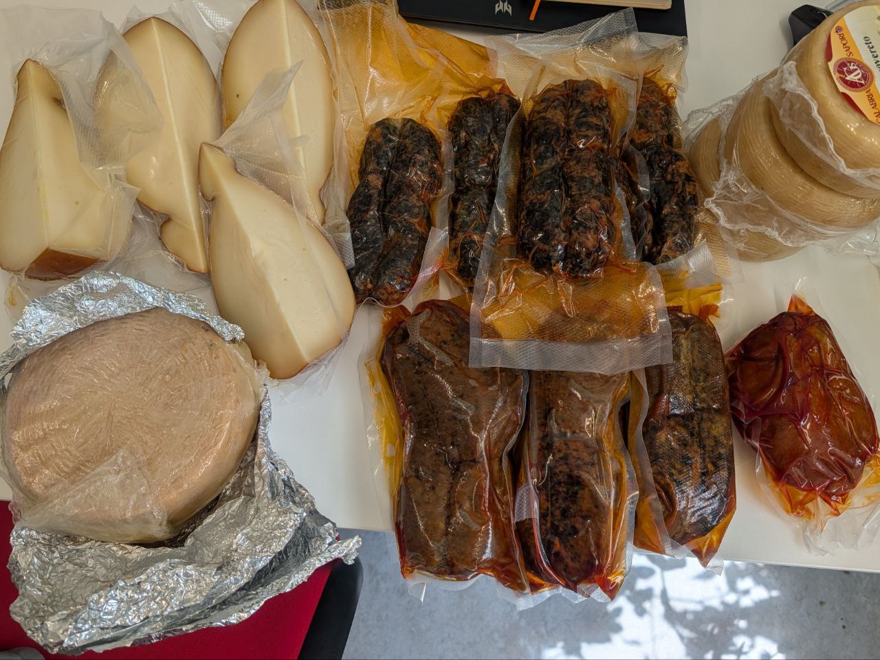 Unpacked Southern Italy products including nduja, salami, and vacuum-sealed cheeses